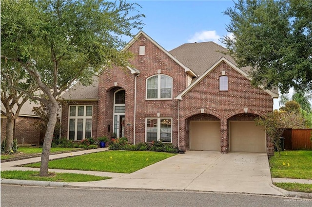 view of front of property featuring a garage and a front yard