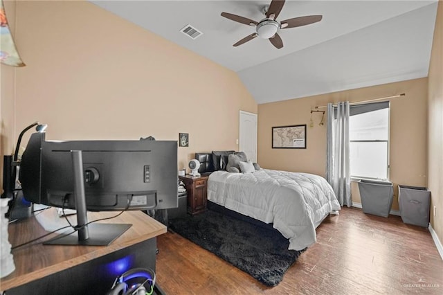 bedroom featuring hardwood / wood-style floors, ceiling fan, and lofted ceiling