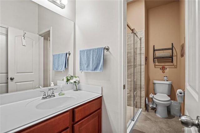 bathroom with tile patterned floors, vanity, toilet, and walk in shower