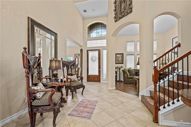 tiled entryway with a towering ceiling