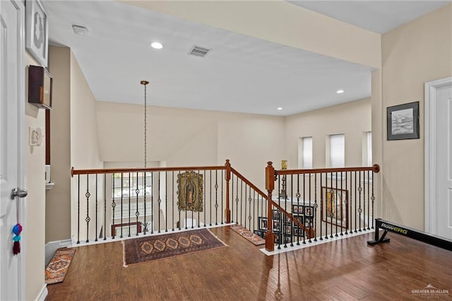 hall with hardwood / wood-style flooring and a healthy amount of sunlight