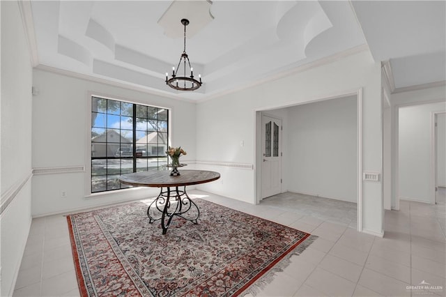 dining room with light tile patterned floors, ornamental molding, a raised ceiling, and a notable chandelier