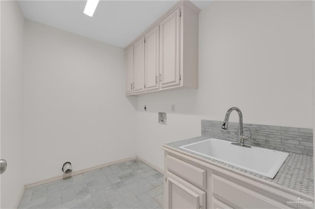 laundry room featuring hookup for a washing machine, cabinet space, a sink, electric dryer hookup, and baseboards