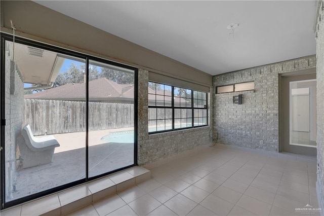 unfurnished sunroom with a healthy amount of sunlight