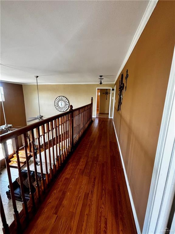 21732 Mile 17 Rd, Edinburg, TX 78541 - corridor featuring ornamental molding, wood finished floors, and baseboards