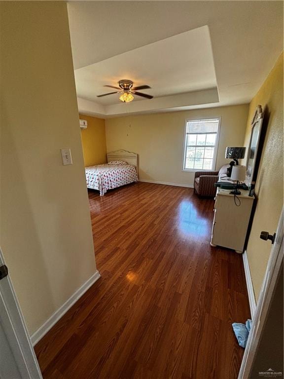 21732 Mile 17 Rd, Edinburg, TX 78541 - bedroom with dark wood-type flooring, a tray ceiling, and baseboards