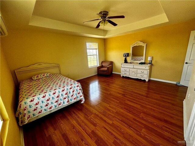 21732 Mile 17 Rd, Edinburg, TX 78541 - bedroom with wood finished floors, ceiling fan, a tray ceiling, and baseboards