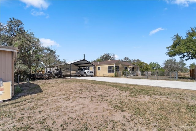 615 Iowa St, Mercedes, TX 78570 - view of yard featuring driveway, a carport, and fence