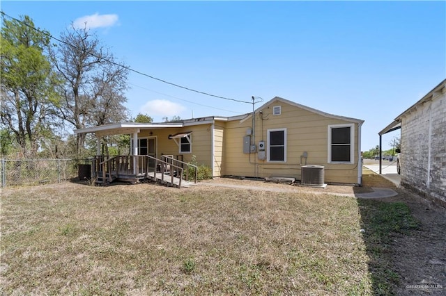 615 Iowa St, Mercedes, TX 78570 - back of property with a lawn, fence, and cooling unit