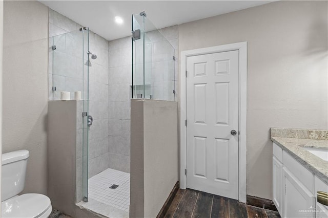 615 Iowa St, Mercedes, TX 78570 - full bath featuring a shower stall, toilet, wood finished floors, and vanity