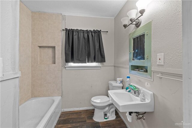 615 Iowa St, Mercedes, TX 78570 - full bathroom featuring toilet, a sink, and wood finish floors