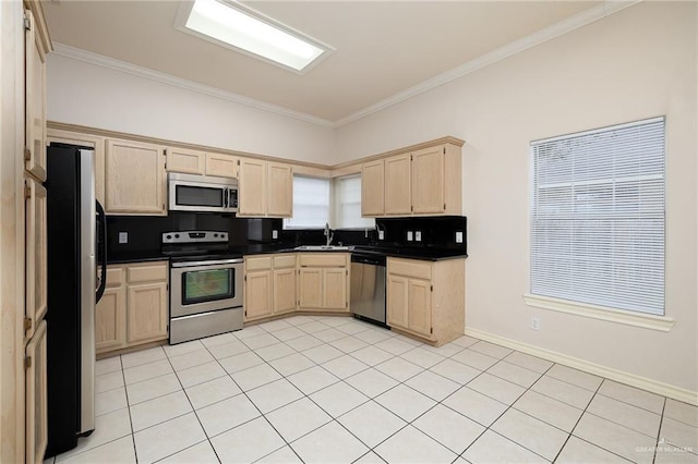 kitchen featuring sink, light brown cabinets, stainless steel appliances, crown molding, and light tile patterned floors