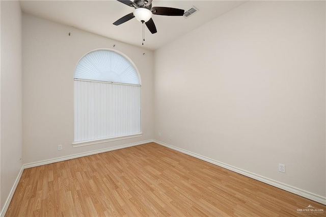 spare room with ceiling fan and light wood-type flooring