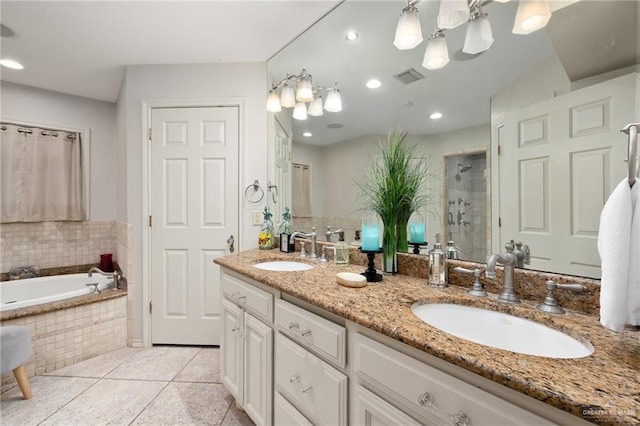 full bathroom featuring tile patterned flooring, a sink, visible vents, and a shower stall