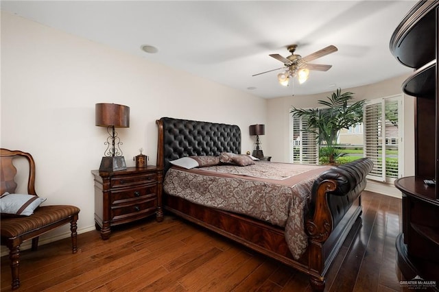 bedroom featuring a ceiling fan, baseboards, and hardwood / wood-style flooring