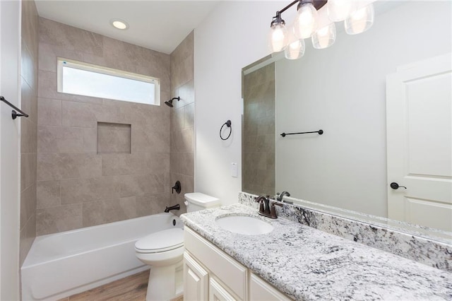 full bathroom with vanity, toilet, wood finished floors, and tub / shower combination