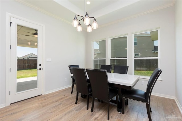 dining space featuring ornamental molding, light wood finished floors, and a healthy amount of sunlight
