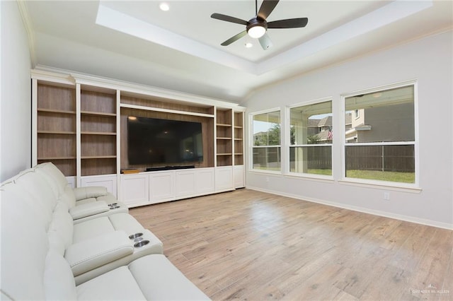 unfurnished living room featuring ceiling fan, light wood-style flooring, recessed lighting, baseboards, and a tray ceiling
