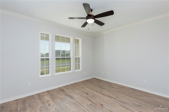 unfurnished room featuring baseboards, ornamental molding, ceiling fan, and light wood-style floors