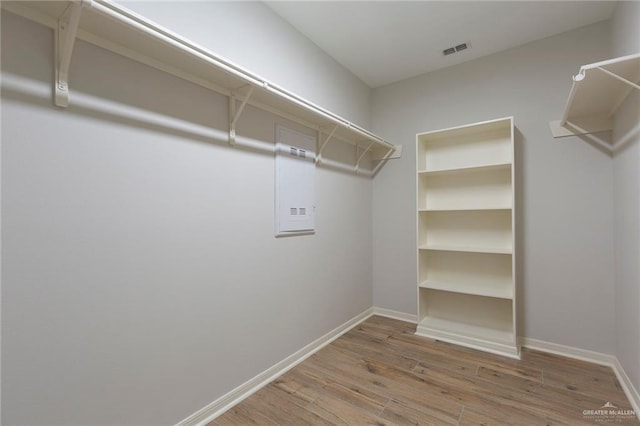 spacious closet featuring visible vents and wood finished floors