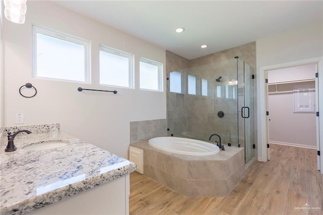 full bath with vanity, wood finished floors, recessed lighting, a bath, and a stall shower