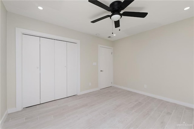 unfurnished bedroom featuring ceiling fan, a closet, and light hardwood / wood-style floors