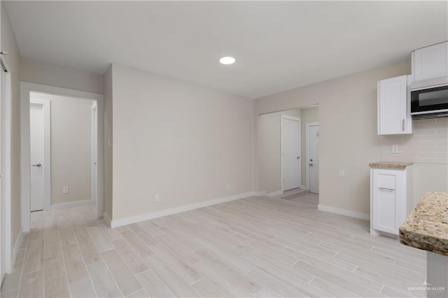 unfurnished living room featuring light wood-type flooring