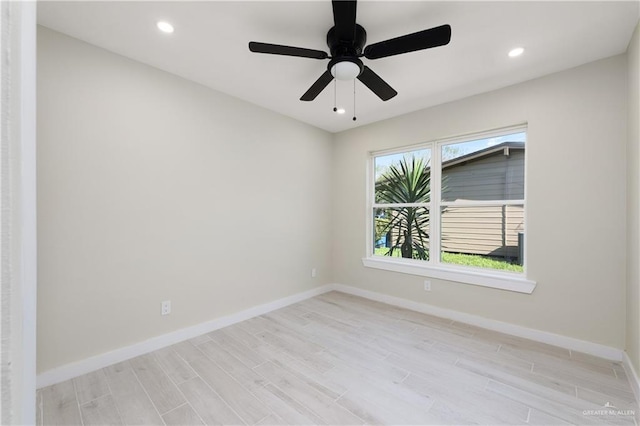 spare room featuring ceiling fan and light wood-type flooring