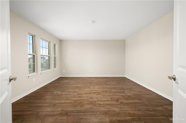 spare room featuring dark wood-type flooring