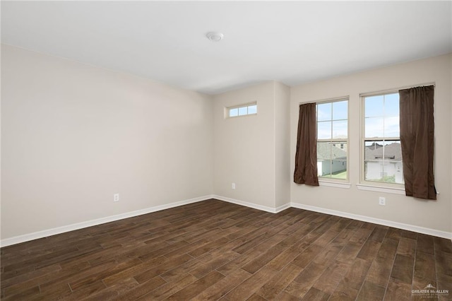 spare room featuring dark wood-type flooring