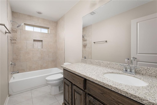 full bathroom featuring toilet, vanity, tile patterned floors, and tiled shower / bath combo