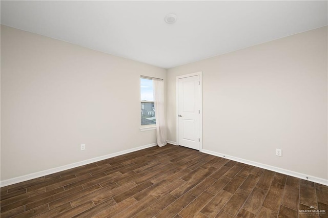 spare room with dark hardwood / wood-style flooring