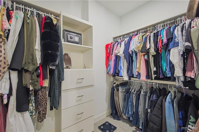 walk in closet with tile patterned floors