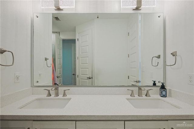 bathroom featuring a sink, visible vents, and double vanity