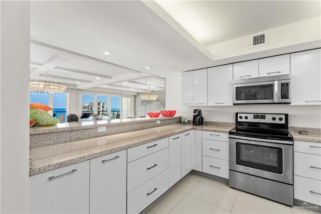 kitchen featuring an inviting chandelier, light stone countertops, beamed ceiling, white cabinetry, and stainless steel appliances