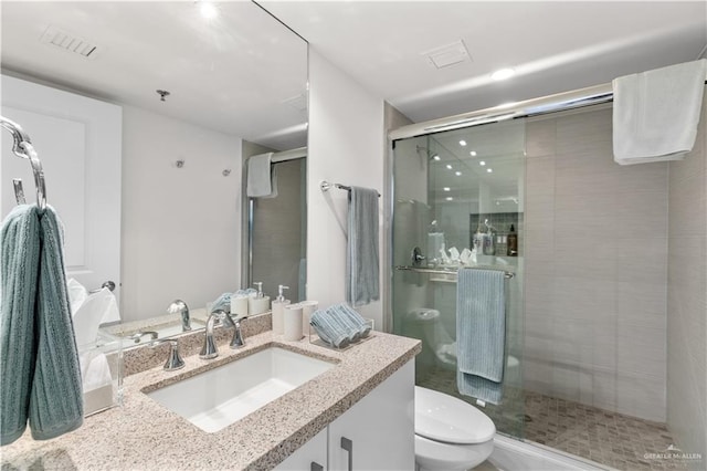 bathroom with vanity, toilet, and walk in shower