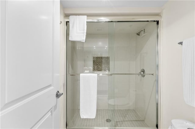 bathroom with tile patterned flooring and an enclosed shower