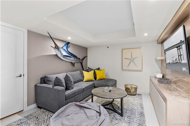 living room featuring a tray ceiling and tile patterned floors