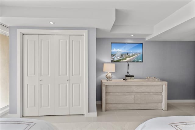 tiled bedroom featuring a closet