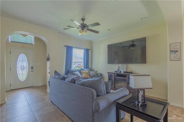 tiled living room featuring ceiling fan and ornamental molding