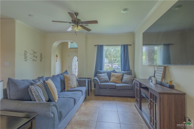 tiled living room with ceiling fan and ornamental molding