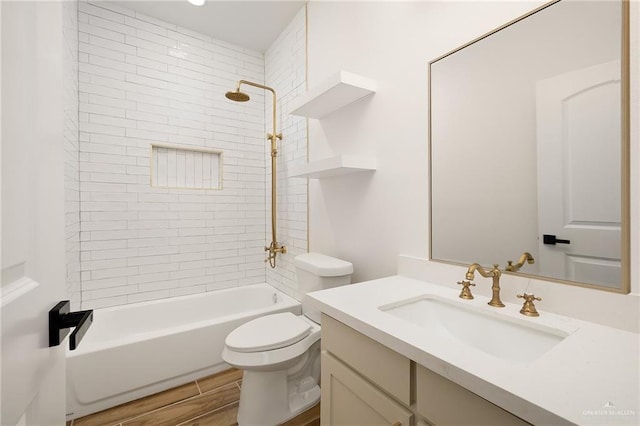 full bathroom featuring vanity, toilet, and tiled shower / bath combo