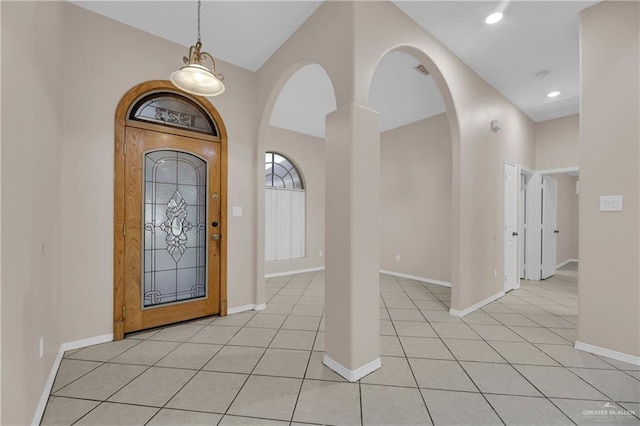 tiled entrance foyer with high vaulted ceiling