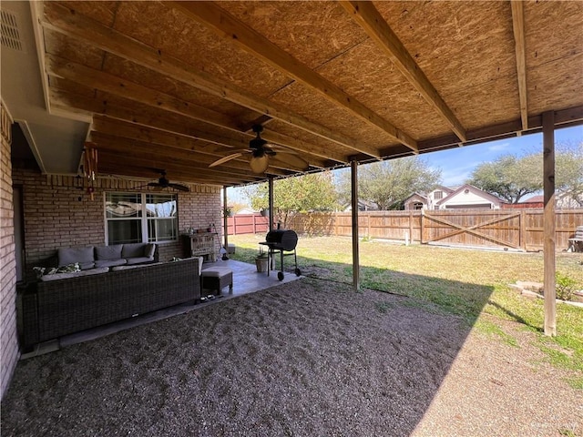 view of yard with a patio area, a fenced backyard, ceiling fan, and an outdoor hangout area