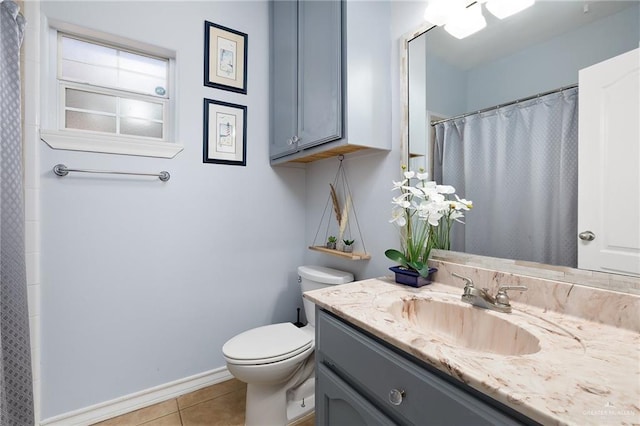 bathroom featuring a shower with curtain, toilet, vanity, tile patterned flooring, and baseboards