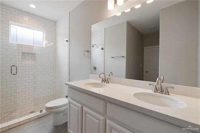 825 S Templo Dorado, Mission, TX 78572 - bathroom featuring a stall shower, toilet, and double vanity