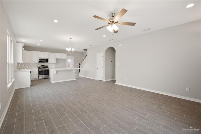 825 S Templo Dorado, Mission, TX 78572 - unfurnished living room with baseboards, wood finished floors, a sink, recessed lighting, and ceiling fan