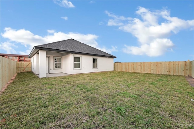 back of property featuring a patio area and a yard