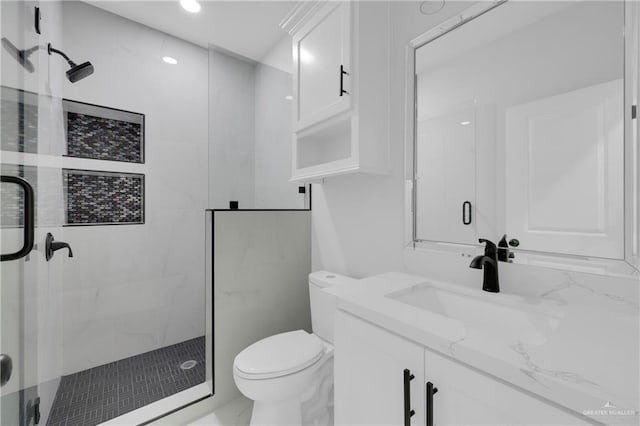 bathroom featuring vanity, toilet, and a shower with door