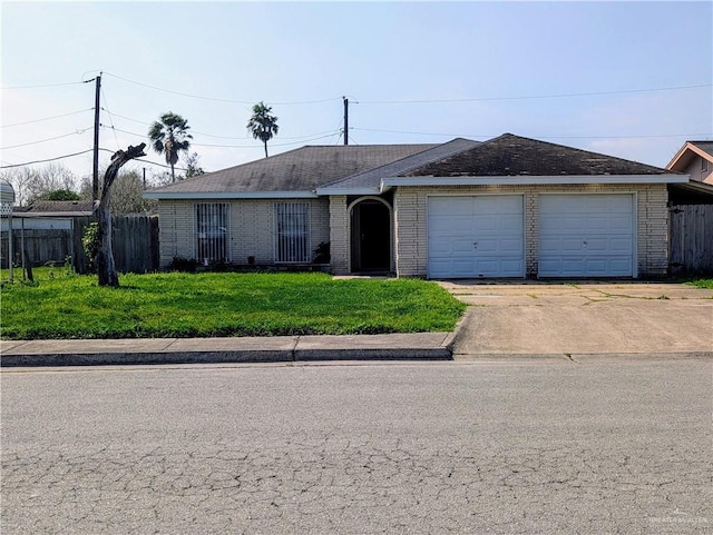 single story home with a garage and a front lawn